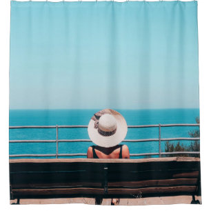 Woman wearing white straw hat sitting on bench loo