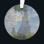 Woman with a Parasol by Claude Monet Ornament<br><div class="desc">Woman with a Parasol - Madame Monet and Her Son by Claude Monet, oil on canvas 1875, is a painting of a woman in a white dress holding an umbrella over her head upon the top of a hill covered in grass and wildflowers, backlit against a brilliant blue sky and...</div>