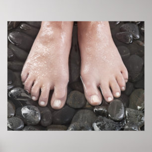Woman's feet on pebbles poster