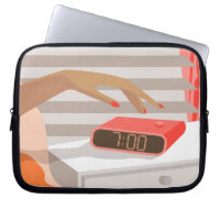 Womans hand pushing on alarm clock snooze button