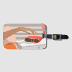 Womans hand pushing on alarm clock snooze button luggage tag