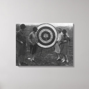 Women examining Archery Target Photograph Canvas Print