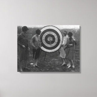 Women examining Archery Target Photograph Canvas Print
