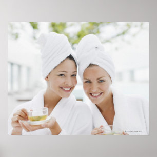 Women in bathrobes drinking tea at spa poster