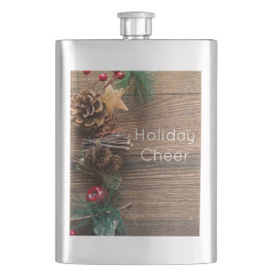 wooden background with pine cones hip flask