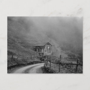 Wooden hut in nature/fog at mountain postcard