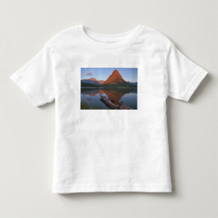 Wooden kayak in Swiftcurrent Lake at sunrise in Toddler T-shirt