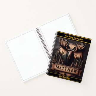 Wooden moose surrounded by nature notebook