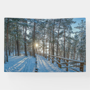 Wooden path across snowy winter forest banner