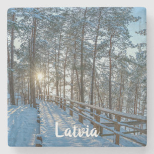 Wooden path across snowy winter forest stone coaster