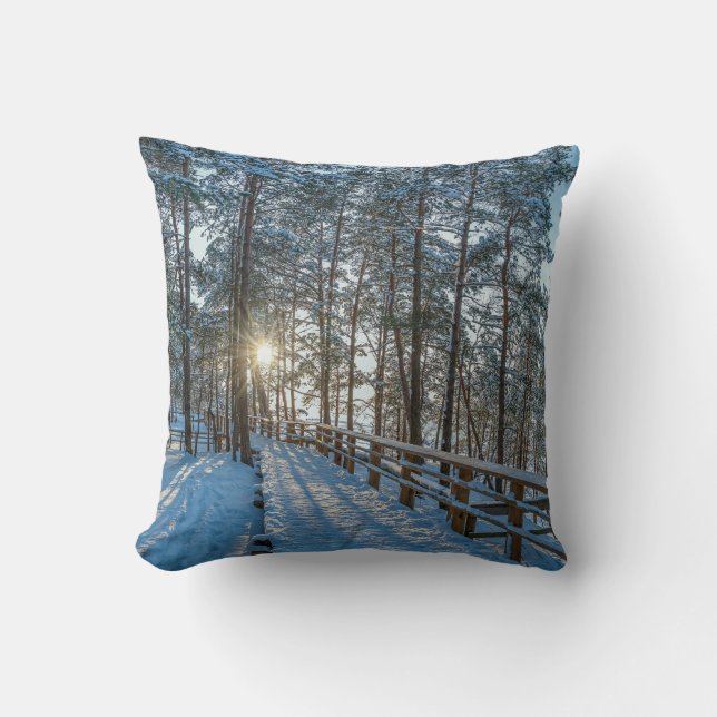 Wooden path across snowy winter forest throw pillow (Front)