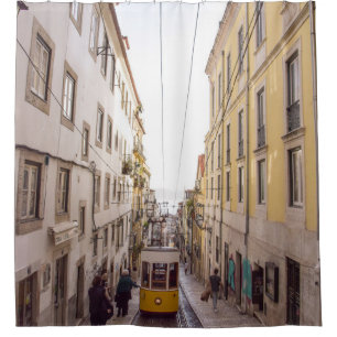 YELLOW AND GREY VEHICLE PASSING ON ROAD