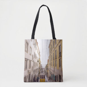 YELLOW AND GREY VEHICLE PASSING ON ROAD TOTE BAG