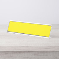 Yellow and orange abstract shapes overlap on a pla