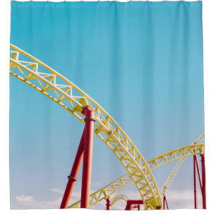 Yellow and red roller coaster under blue sky at da