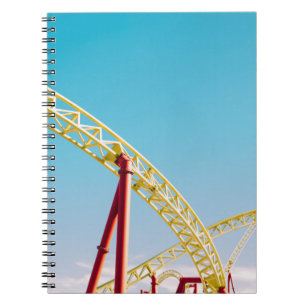 Yellow and red roller coaster under blue sky at da notebook