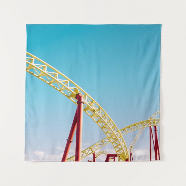 Yellow and red roller coaster under blue sky at da tapestry (Front)