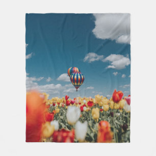 Yellow and red tulip flowers under hot air balloon fleece blanket