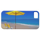 Yellow beach umbrella and chairs on pristine