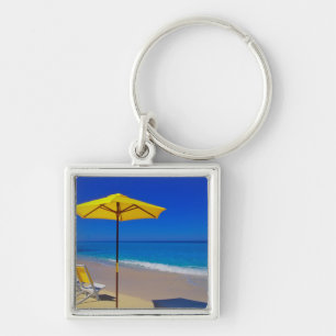 Yellow beach umbrella and chairs on pristine keychain