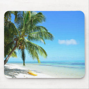 Yellow kayak on a white sand beach mousepad