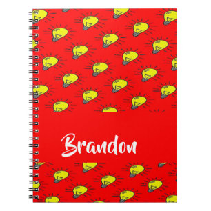 Yellow light bulbs on red notebook
