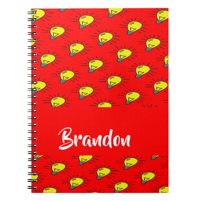 Yellow light bulbs on red notebook (Front)