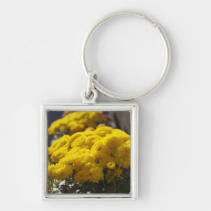 Yellow marigolds bask in sunlight keychain