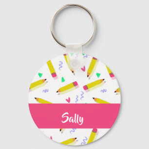 Yellow pencils and scrabbles on white keychain