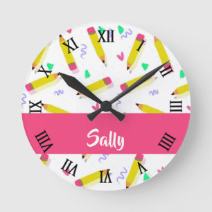 Yellow pencils and scrabbles on white round clock