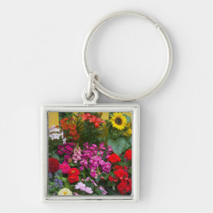 Yellow picket fence with flower garden in keychain