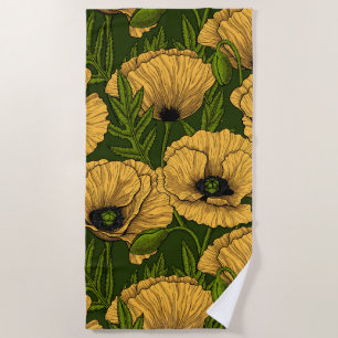 Yellow poppies on dark green beach towel
