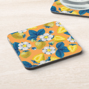Yellow strawberries on orange coaster