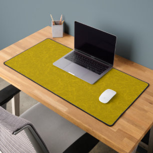 Yellow textured surface with  swirling pattern desk mat