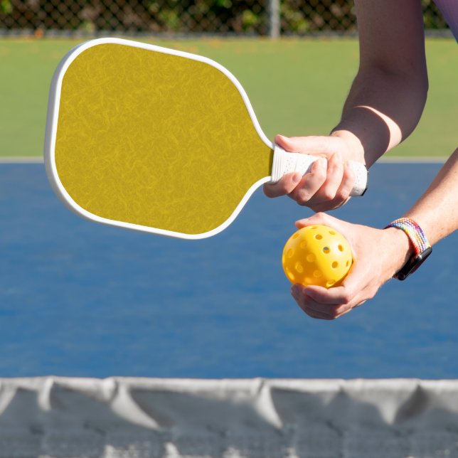 Yellow textured surface with  swirling pattern pickleball paddle (Insitu)
