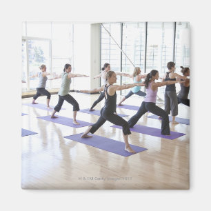 Yoga instructor teaching a class of women the magnet