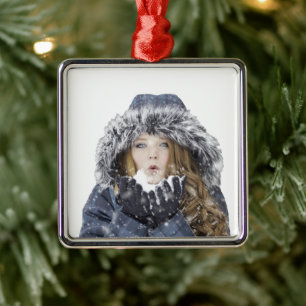 Young beautiful girl in winter metal ornament