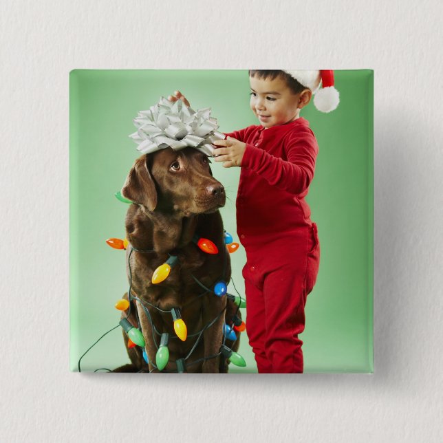 Young boy wrapping Christmas lights around a dog 2 Inch Square Button (Front)