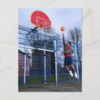 Young man playing basketball outdoors