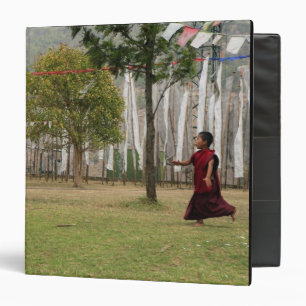 Young monk and prayer flags binder