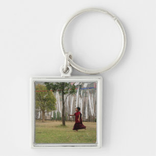 Young monk and prayer flags keychain