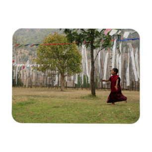 Young monk and prayer flags magnet