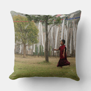 Young monk and prayer flags throw pillow