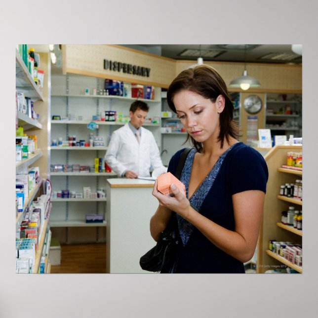 Young woman looking at medicine in pharmacy, poster (Front)