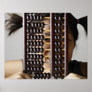 Young woman peering through abacus. poster