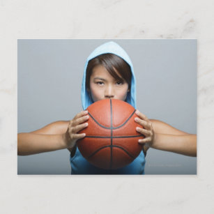 Young woman with basketball looking at camera postcard